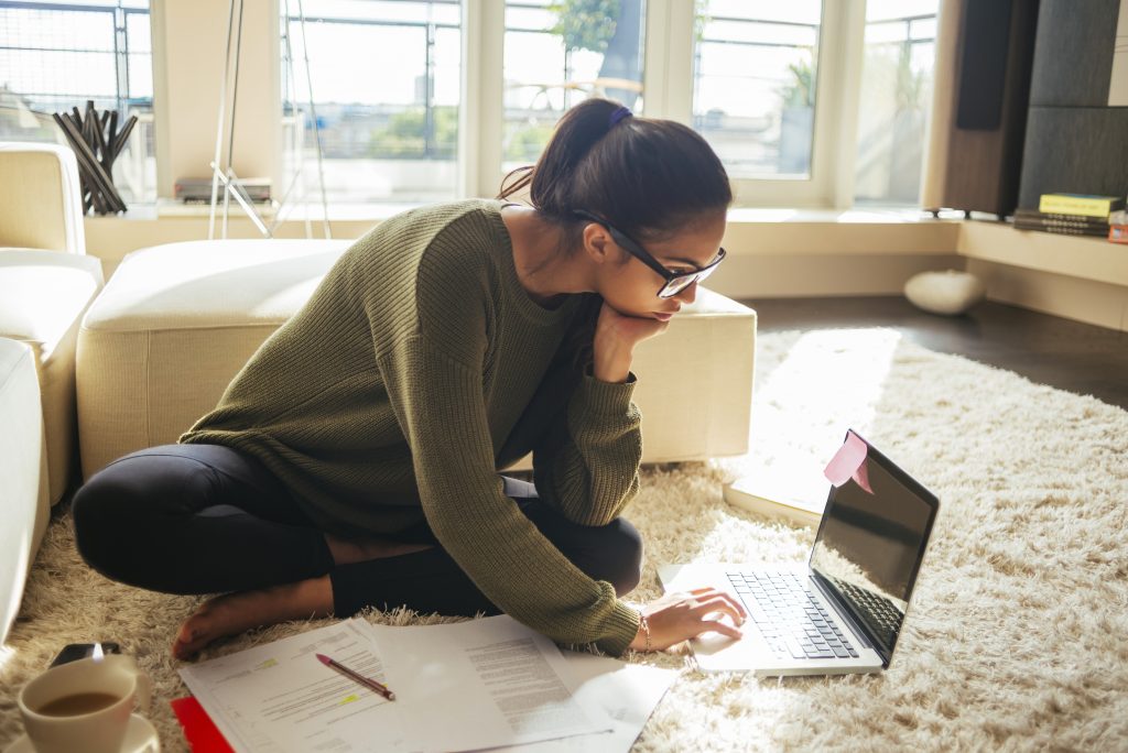 young woman studying and working on her laptop