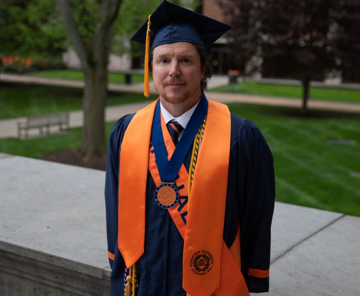 a male student in graduation regalia