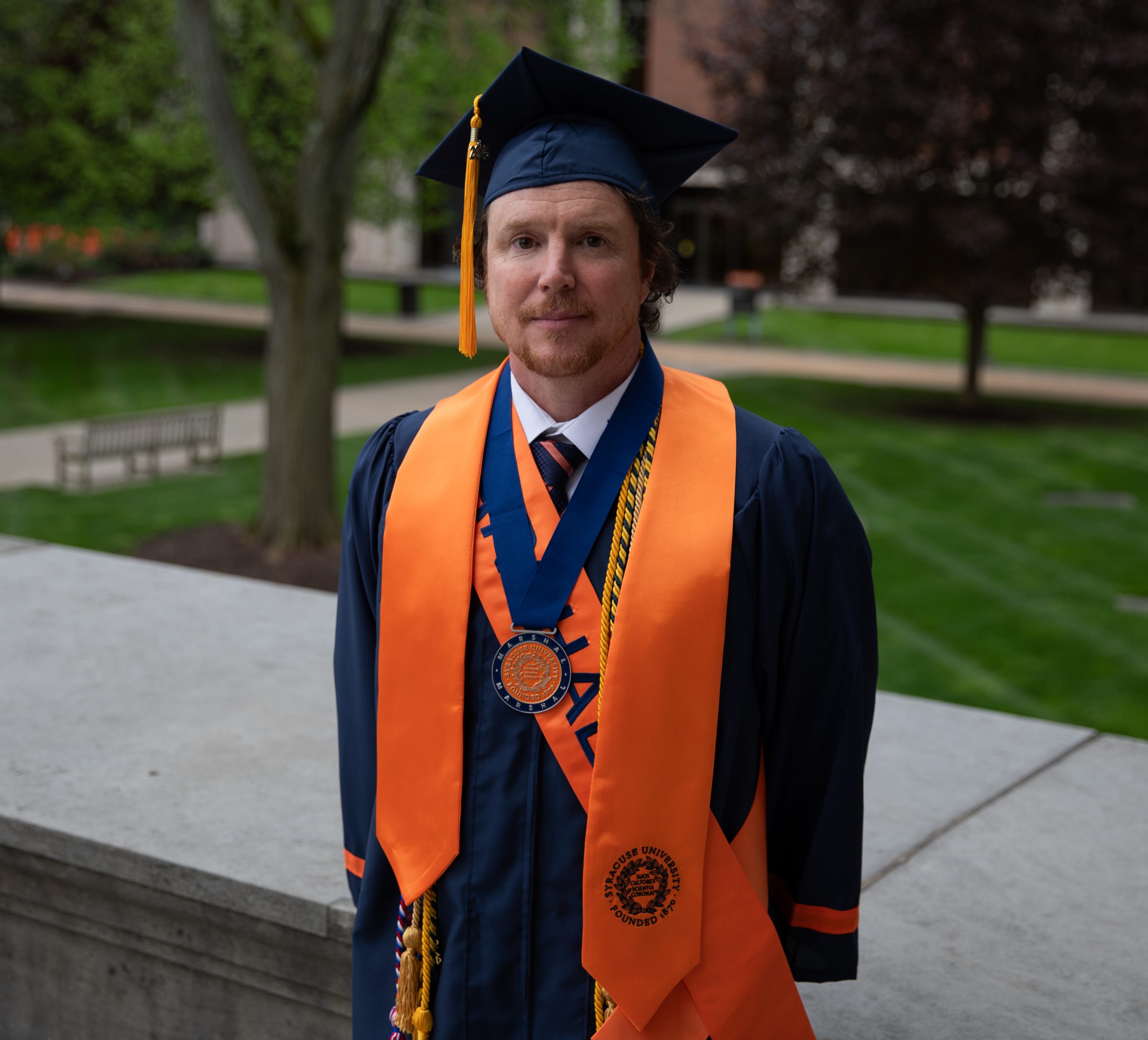 a male student in graduation regalia