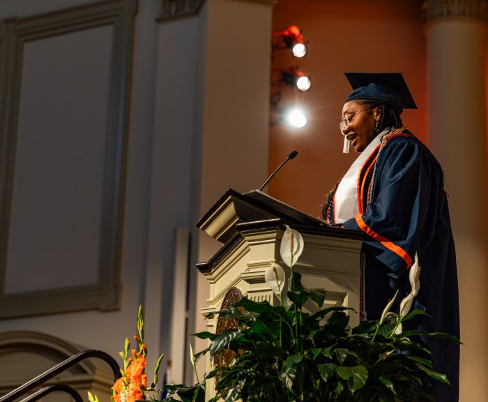 A student speaks at a podium at the 2024 convocation.