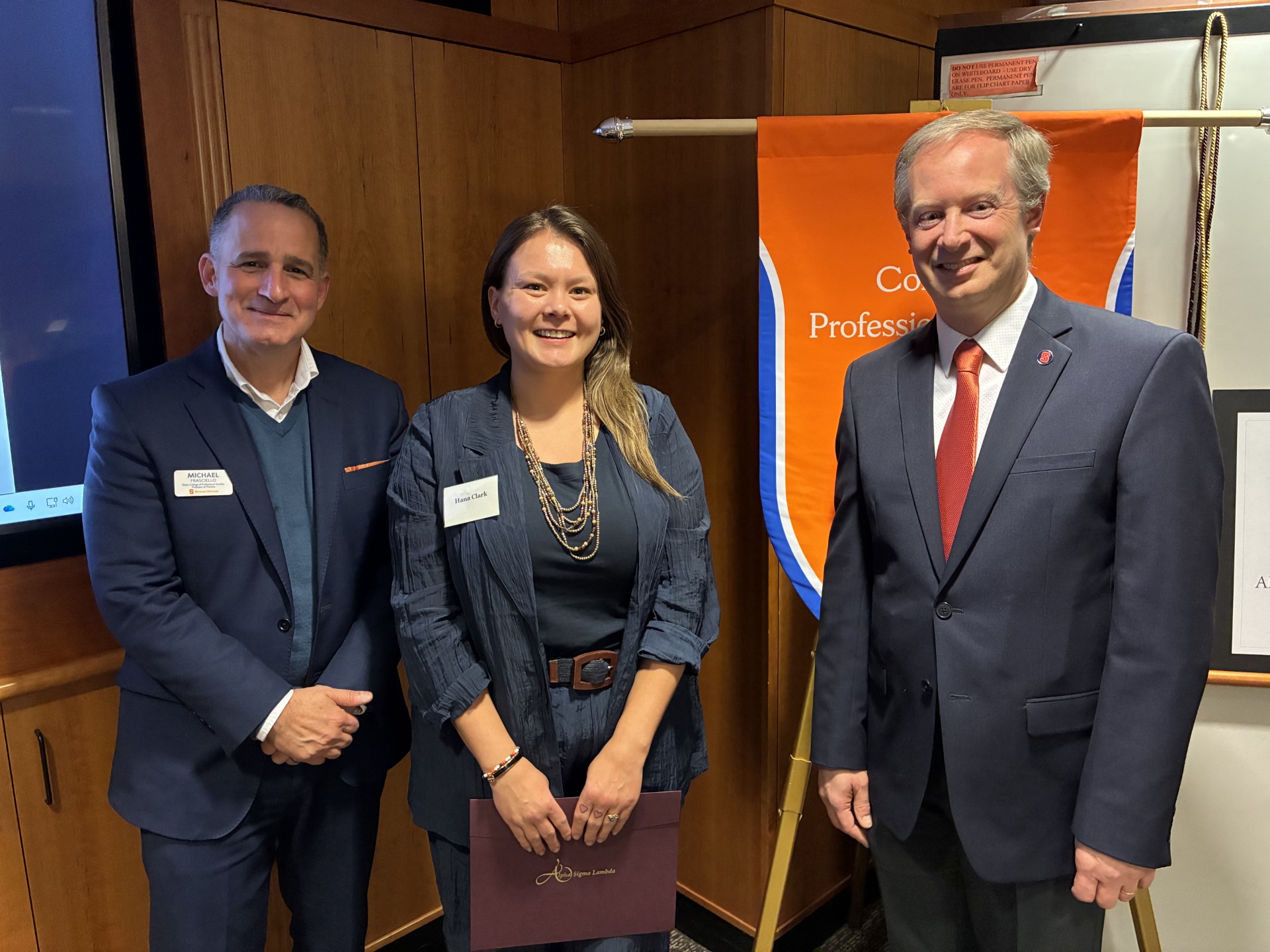 Dean Michael Frasciello and Senior Associate Dean Ryan O. Williams take a photo with a student. 