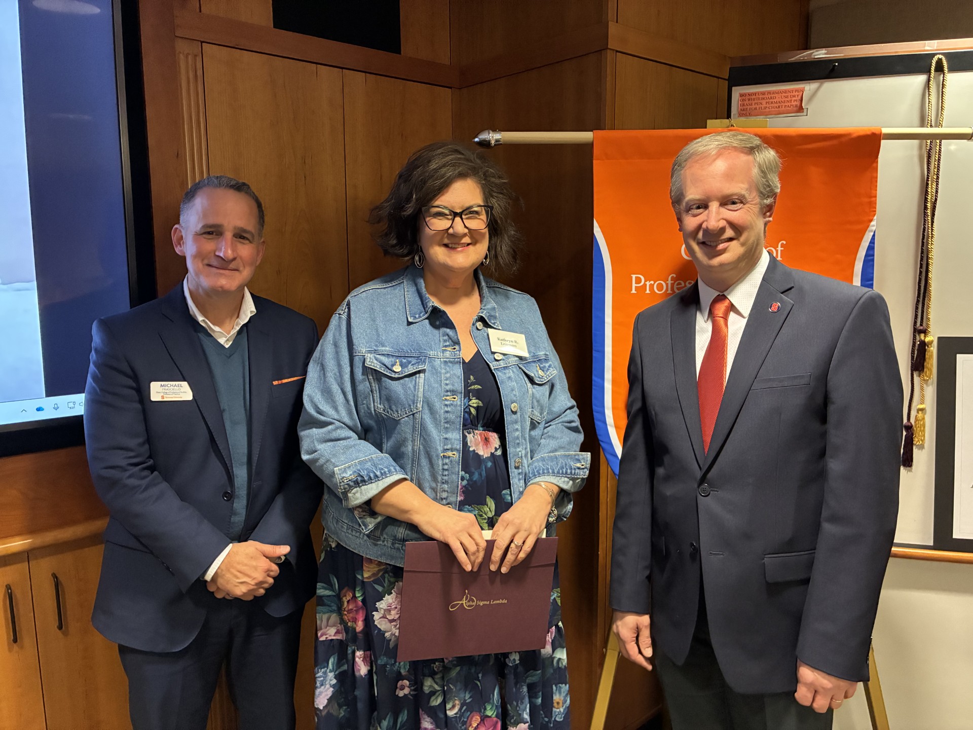 Dean Michael Frasciello and Senior Associate Dean Ryan O. Williams take a photo with a student. 