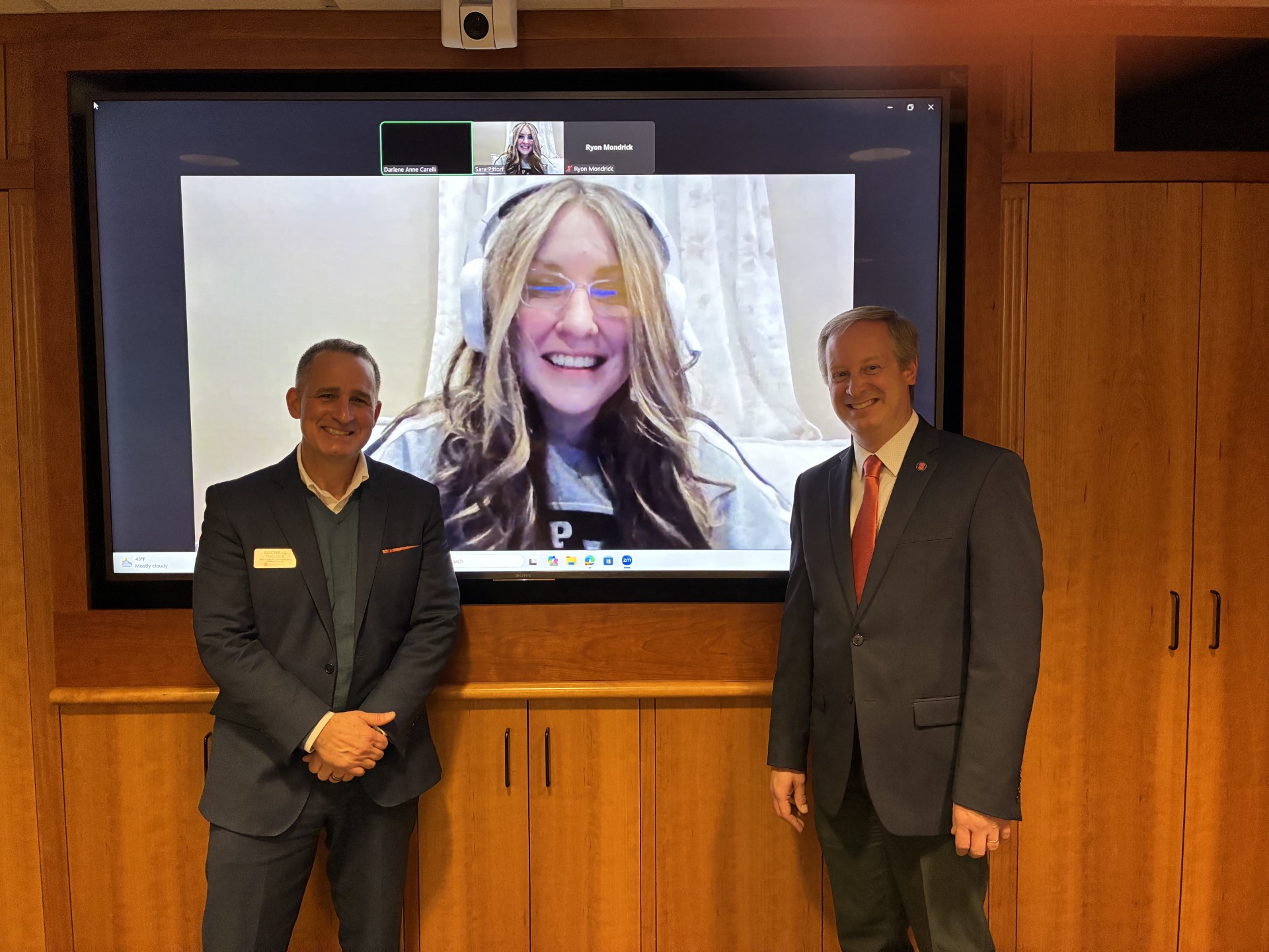 Dean Michael Frasciello and Senior Associate Dean Ryan O. Williams take a photo with a student on a Zoom video call. 