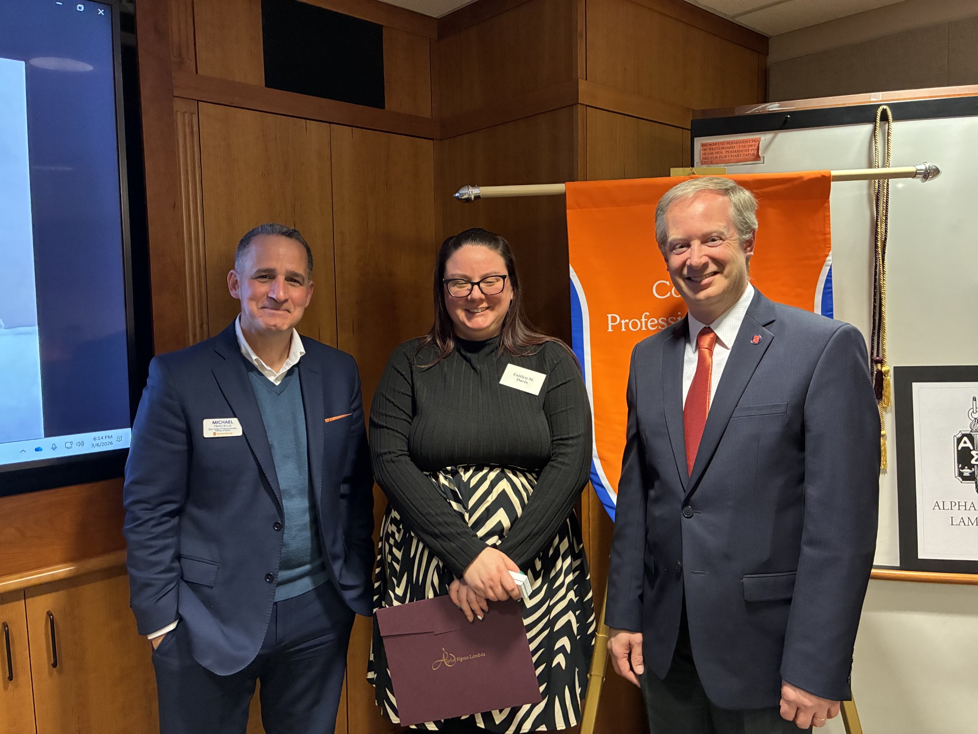 Dean Michael Frasciello and Senior Associate Dean Ryan O. Williams take a photo with a student. 