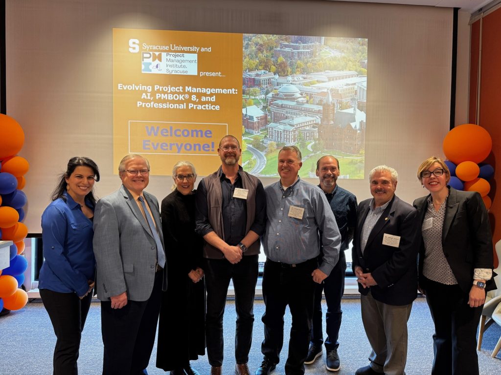 Eight Syracuse University and Project Management Institute leaders gather for a group photo.